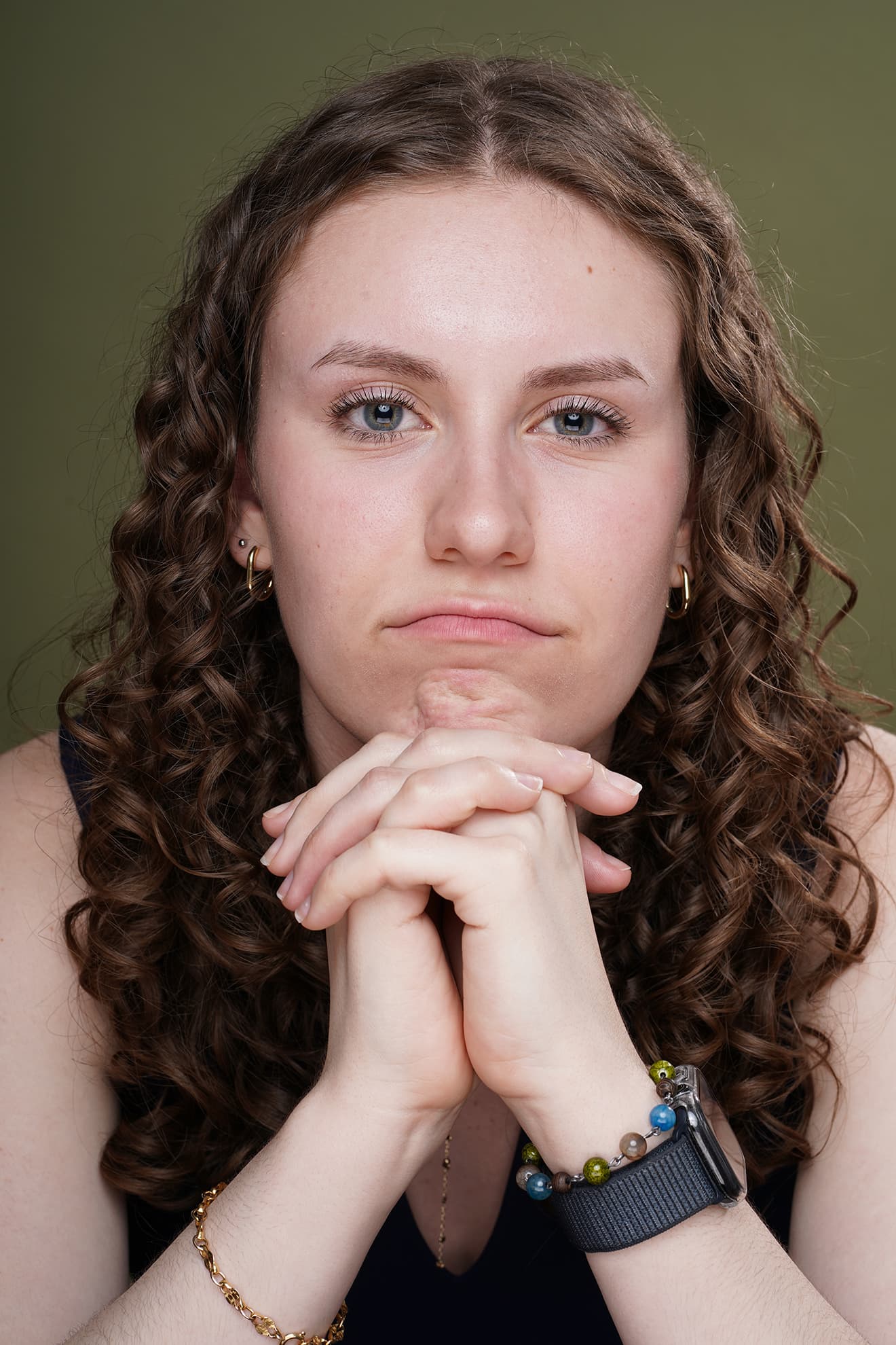 Maya Cassell playful headshot on a green backdrop